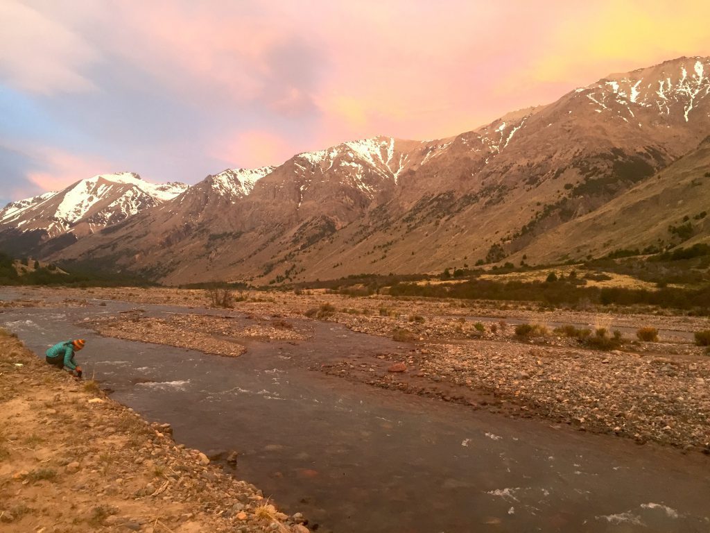 HMI Gap student getting water from a pristine river in Parque Patagonia