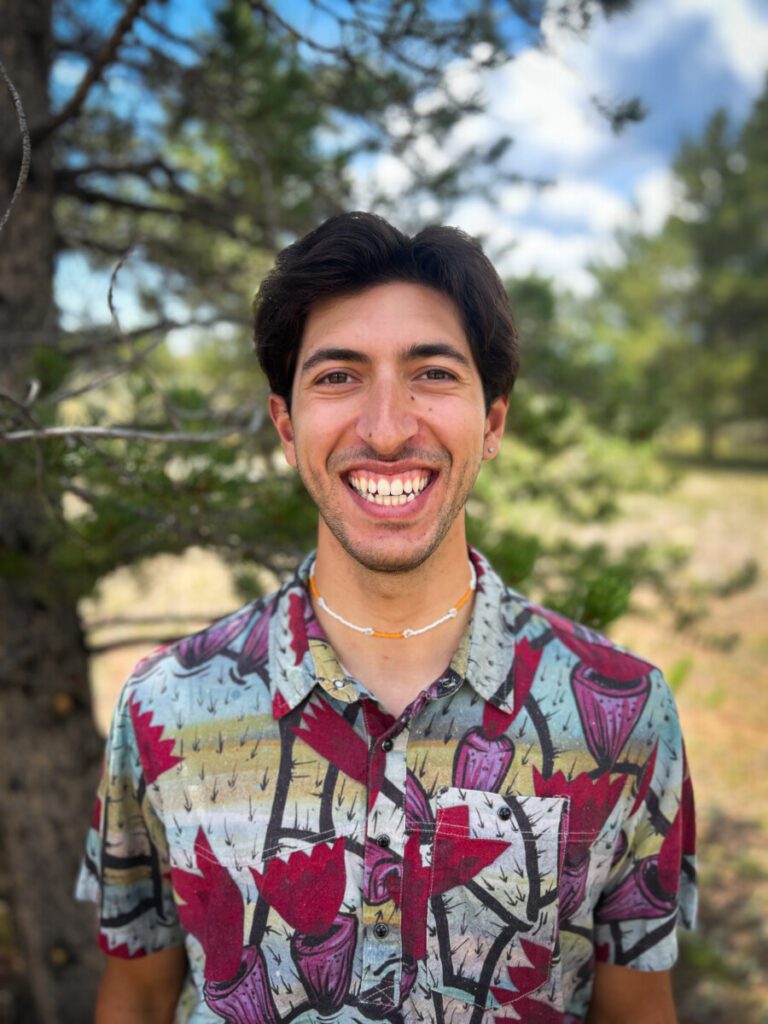 Raffi smiling outside